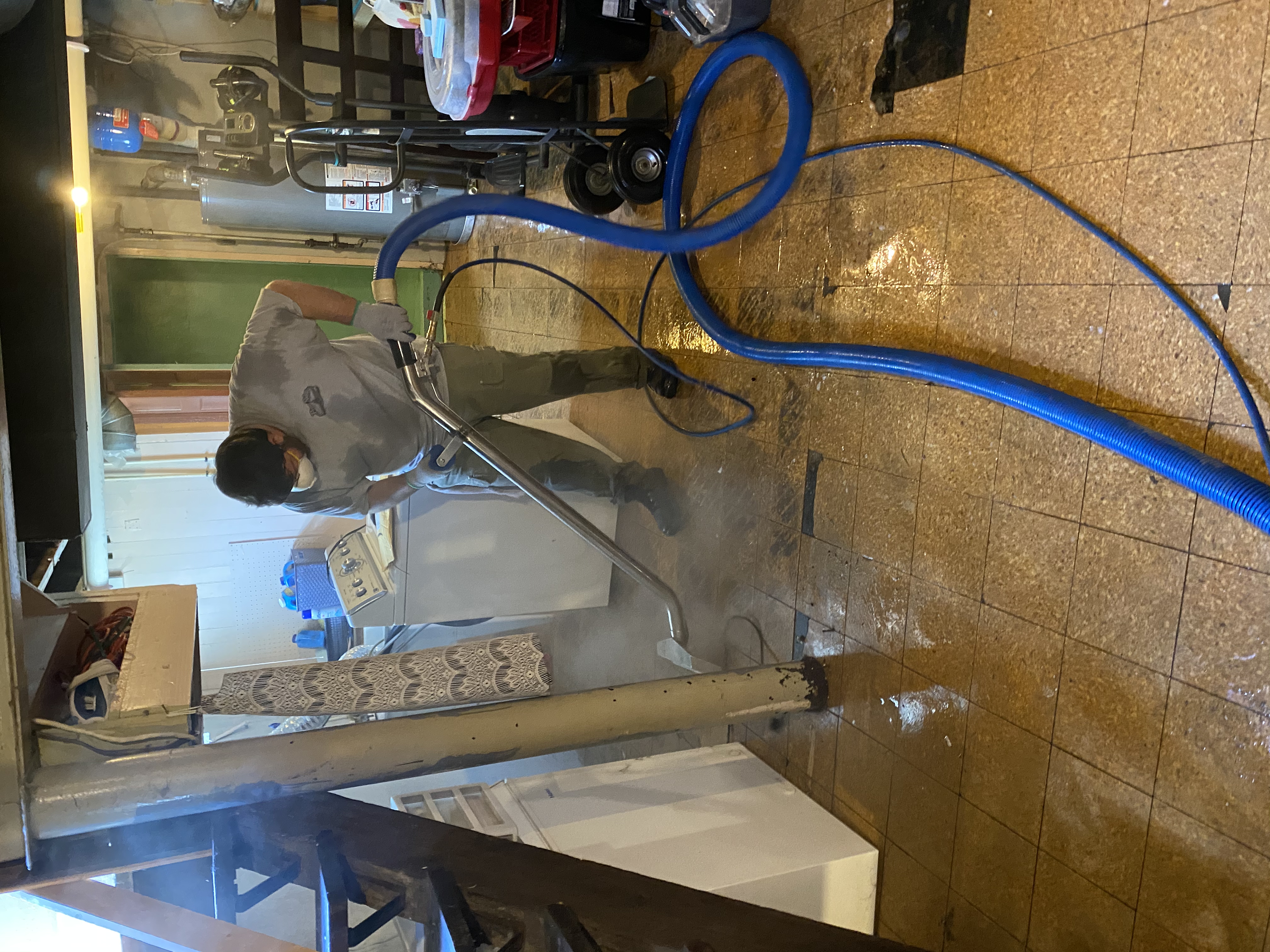 Photo of workers wet vaccing a floor